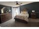 A well-appointed main bedroom features a bed, dresser, nightstand, and light from the window at 503 Tivoli Park Dr, Davenport, FL 33897