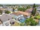 Aerial view of a home with a screened pool, nestled in a vibrant residential neighborhood at 521 Rena Dr, Davenport, FL 33897