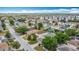 An aerial view captures a lively residential area filled with trees and diverse architectural styles at 521 Rena Dr, Davenport, FL 33897