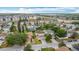 An aerial view of a residential neighborhood with well-maintained homes and green spaces on a sunny day at 521 Rena Dr, Davenport, FL 33897
