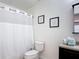 Cozy bathroom with a shower-tub combo, decorative artwork, and a toilet at 521 Rena Dr, Davenport, FL 33897