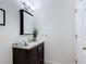 Dark-stained vanity with a mirror and decorative accents in a well-lit bathroom at 521 Rena Dr, Davenport, FL 33897