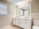 This bathroom features an updated double sink vanity with marble countertops and updated fixtures at 521 Rena Dr, Davenport, FL 33897