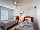 Whimsical bedroom features twin beds, decorative wall art, and a ceiling fan at 521 Rena Dr, Davenport, FL 33897