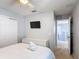 This light and bright bedroom offers a ceiling fan, closet, TV, and an adjoining hallway at 521 Rena Dr, Davenport, FL 33897