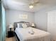 Charming bedroom featuring a queen-sized bed, neutral walls, and a ceiling fan at 521 Rena Dr, Davenport, FL 33897