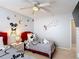 Charming bedroom with twin beds, themed decor, and a bright ceiling fan at 521 Rena Dr, Davenport, FL 33897