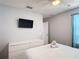 Neutral-toned bedroom with a TV, ceiling fan, and plenty of natural light at 521 Rena Dr, Davenport, FL 33897