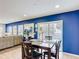 Dining area boasts blue walls, a wood table set, and sliding glass doors to the pool at 521 Rena Dr, Davenport, FL 33897