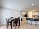 Open dining area with a four-seat table, seamlessly connecting to the modern kitchen for easy entertaining at 521 Rena Dr, Davenport, FL 33897