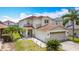 Two-story home with a two-car garage, manicured lawn, and decorative rock landscaping at 521 Rena Dr, Davenport, FL 33897