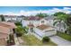 A lushly landscaped two-story home with a two-car garage, featuring palm trees and green grass at 521 Rena Dr, Davenport, FL 33897
