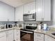 Kitchen boasts granite countertops and stainless steel appliances for a modern touch at 521 Rena Dr, Davenport, FL 33897