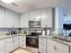Well-equipped kitchen features stainless steel appliances and granite countertops at 521 Rena Dr, Davenport, FL 33897