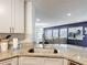 Gourmet kitchen with granite countertops and stainless steel sink that overlooks the living room at 521 Rena Dr, Davenport, FL 33897