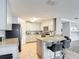 Bright kitchen features granite countertops, stainless steel appliances, and a breakfast bar at 521 Rena Dr, Davenport, FL 33897