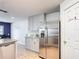 Updated kitchen with granite countertops and stainless steel refrigerator near the dining area at 521 Rena Dr, Davenport, FL 33897