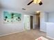 Bright living room features neutral colors, ceiling fan, carpeted flooring, and coastal-themed artwork at 521 Rena Dr, Davenport, FL 33897