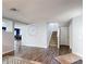 Open-concept living area with sleek wood flooring and a view of the staircase and dining area at 521 Rena Dr, Davenport, FL 33897