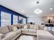 Expansive living room showcasing a large sectional sofa, modern lighting, and views of the dining and kitchen area at 521 Rena Dr, Davenport, FL 33897