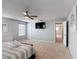 Spacious main bedroom with a TV, ceiling fan, and neutral decor with an open entry at 521 Rena Dr, Davenport, FL 33897