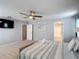 This main bedroom features a ceiling fan, neutral colors, and easy access to the walk in closet at 521 Rena Dr, Davenport, FL 33897