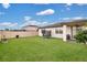 Spacious backyard featuring a green lawn, privacy fence, and a small trampoline at 527 Amadoras Way, St Cloud, FL 34771