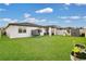 Spacious backyard with lush green grass, white fence, and a trampoline at 527 Amadoras Way, St Cloud, FL 34771