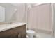 Well-lit bathroom featuring a single sink vanity and tub with shower curtain at 527 Amadoras Way, St Cloud, FL 34771