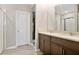 Bright bathroom features double sinks, dark wood cabinets, and a walk-in closet at 527 Amadoras Way, St Cloud, FL 34771
