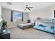 Spacious bedroom with carpeted flooring, a ceiling fan, and plenty of natural light at 527 Amadoras Way, St Cloud, FL 34771