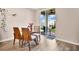 Cozy dining area with a glass-top table, modern chairs, and access to the backyard at 527 Amadoras Way, St Cloud, FL 34771