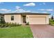 Charming single-story home featuring a brick driveway and attached two car garage at 527 Amadoras Way, St Cloud, FL 34771