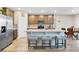 Modern kitchen featuring a central island with seating, stainless steel appliances, and wood cabinets at 527 Amadoras Way, St Cloud, FL 34771