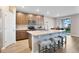 Well-equipped kitchen with wooden cabinets, stainless steel appliances, and an island with bar stools at 527 Amadoras Way, St Cloud, FL 34771