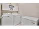 Efficient laundry room equipped with appliances and storage cabinets at 527 Amadoras Way, St Cloud, FL 34771