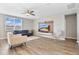 Bright living room with light-colored hardwood floors, neutral walls, and modern furniture at 527 Amadoras Way, St Cloud, FL 34771