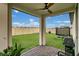 Covered patio with brick flooring, a ceiling fan, and views of the backyard and neighborhood at 527 Amadoras Way, St Cloud, FL 34771