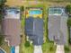 This property features a screened-in pool, neighboring homes, and a lush landscape with distant golf course view at 550 Canary Island Cir, Davenport, FL 33837