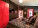 Dark bedroom with black walls, Gucci-themed bedding, and a partial view of the ensuite at 550 Canary Island Cir, Davenport, FL 33837