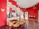 Spacious dining room features stylish lighting, a contemporary glass table, and open access to the kitchen at 550 Canary Island Cir, Davenport, FL 33837