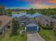 Beautiful single-Gathering home with lush lawn, mature trees, and stunning lake view at sunset at 550 Canary Island Cir, Davenport, FL 33837
