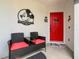 Welcoming front entrance featuring a red door, decorative accents, and comfortable seating area at 550 Canary Island Cir, Davenport, FL 33837