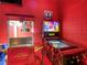 A popcorn machine and Marvel pinball machine create a fun and engaging game room experience at 550 Canary Island Cir, Davenport, FL 33837