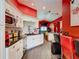 Contemporary kitchen with white cabinetry, black countertops, and colorful, decorative accents at 550 Canary Island Cir, Davenport, FL 33837