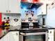 Modern kitchen features stainless steel appliances, sleek black countertops, and stylish backsplash at 550 Canary Island Cir, Davenport, FL 33837