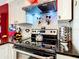 Modern kitchen features stainless steel appliances, sleek black countertops, and stylish backsplash at 550 Canary Island Cir, Davenport, FL 33837