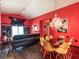 Bright open-concept living and dining area with a modern chandelier, comfortable seating, and decorative accents at 550 Canary Island Cir, Davenport, FL 33837