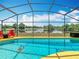Sparkling screened-in pool area with a view of the golf course at 550 Canary Island Cir, Davenport, FL 33837
