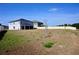 A spacious backyard featuring a screened in porch and a partial view of the neighborhood fencing at 673 Sarner Pass Way, Winter Haven, FL 33881